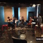 Sandesh Nagaraj conduction the string quartet at a recording session at Ultimate Studios, Inc